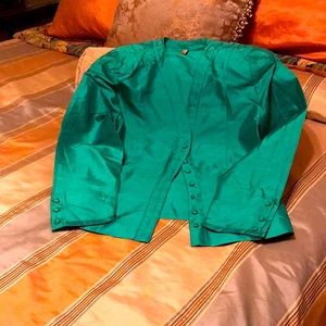 100 percent silk buttoned front and sleeve. Fitted v-neck